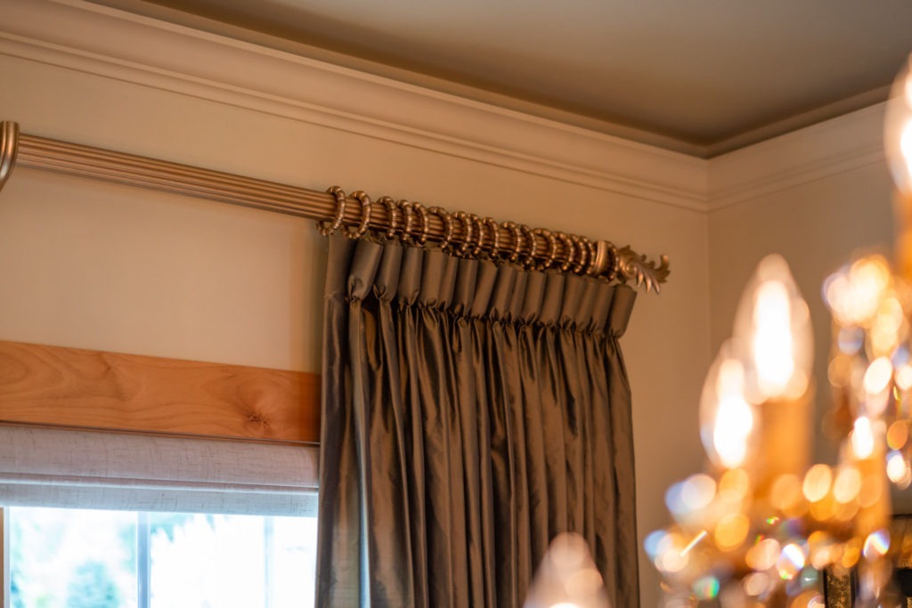 bronze colored silk drapery with goblet pleats on gold wood rod
