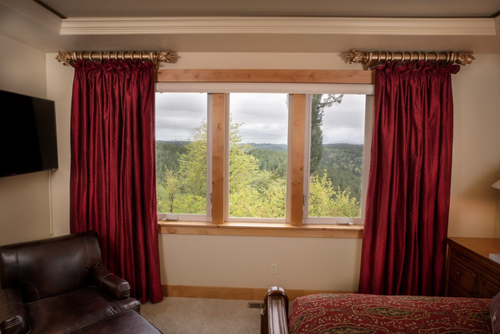 red silk drapery framing window in bedroom